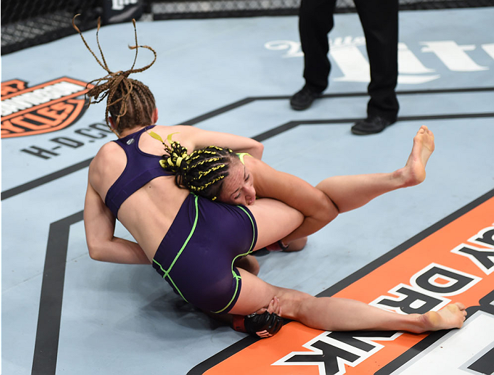 LAS VEGAS, NEVADA - DECEMBER 12: (R-L) Carla Esparza takes down Rose Namajunas in their strawweight championship fight during The Ultimate Fighter Finale event inside the Pearl concert theater at the Palms Casino Resort on December 12, 2014 in Las Vegas,