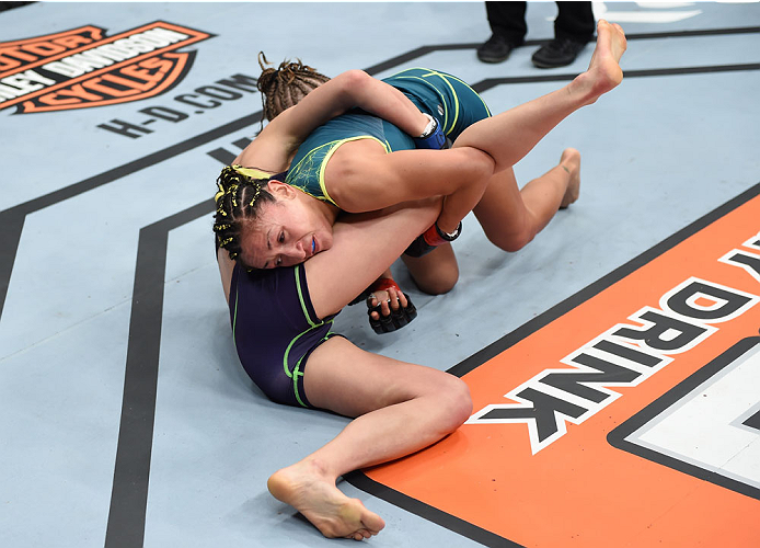 LAS VEGAS, NEVADA - DECEMBER 12: (R-L) Carla Esparza takes down Rose Namajunas in their strawweight championship fight during The Ultimate Fighter Finale event inside the Pearl concert theater at the Palms Casino Resort on December 12, 2014 in Las Vegas,