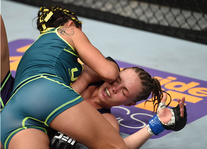 LAS VEGAS, NEVADA - DECEMBER 12: Carla Esparza (top) elbows Rose Namajunas in their strawweight championship fight during The Ultimate Fighter Finale event inside the Pearl concert theater at the Palms Casino Resort on December 12, 2014 in Las Vegas, Nev