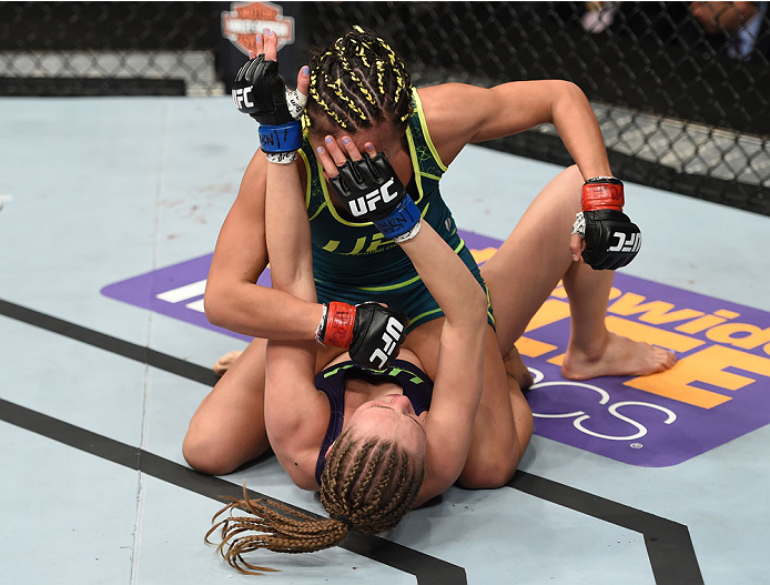 LAS VEGAS, NEVADA - DECEMBER 12: Carla Esparza (top) punches Rose Namajunas in their strawweight championship fight during The Ultimate Fighter Finale event inside the Pearl concert theater at the Palms Casino Resort on December 12, 2014 in Las Vegas, Ne