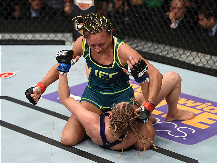 LAS VEGAS, NEVADA - DECEMBER 12: Carla Esparza (top) punches Rose Namajunas in their strawweight championship fight during The Ultimate Fighter Finale event inside the Pearl concert theater at the Palms Casino Resort on December 12, 2014 in Las Vegas, Ne