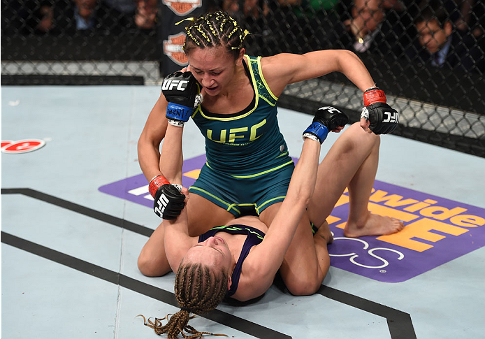 LAS VEGAS, NEVADA - DECEMBER 12: Carla Esparza (top) punches Rose Namajunas in their strawweight championship fight during The Ultimate Fighter Finale event inside the Pearl concert theater at the Palms Casino Resort on December 12, 2014 in Las Vegas, Ne