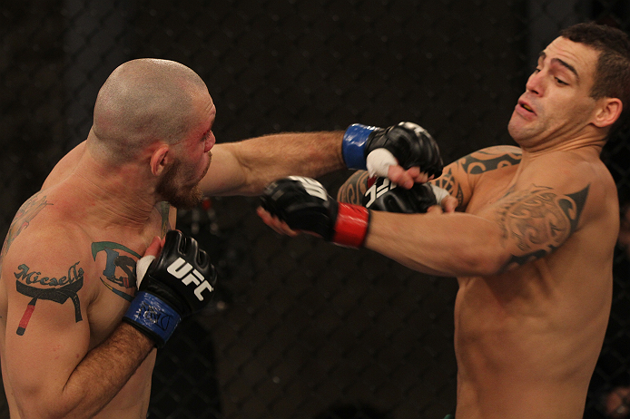 SAO PAULO, BRAZIL - FEBRUARY 11:  (L-R) Marcio "Pedra" Santos punches Santiago Ponzinibbio in their preliminary fight during filming of season two of The Ultimate Fighter Brazil on February 11, 2013 in Sao Paulo, Brazil. (Photo by Luiz Pires Dias/Zuffa LL