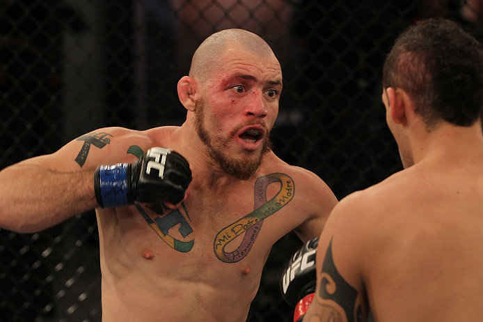 SAO PAULO, BRAZIL - FEBRUARY 11:  (L-R) Marcio "Pedra" Santos punches Santiago Ponzinibbio in their preliminary fight during filming of season two of The Ultimate Fighter Brazil on February 11, 2013 in Sao Paulo, Brazil. (Photo by Luiz Pires Dias/Zuffa LL