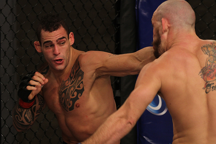 SAO PAULO, BRAZIL - FEBRUARY 11: (L-R) Santiago Ponzinibbio punches Marcio "Pedra" Santos in their preliminary fight during filming of season two of The Ultimate Fighter Brazil on February 11, 2013 in Sao Paulo, Brazil. (Photo by Luiz Pires Dias/Zuffa LL
