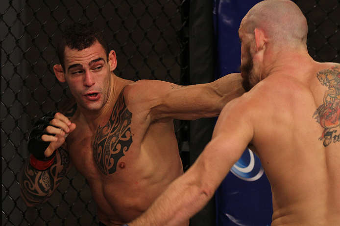 SAO PAULO, BRAZIL - FEBRUARY 11:  (L-R) Santiago Ponzinibbio punches Marcio "Pedra" Santos in their preliminary fight during filming of season two of The Ultimate Fighter Brazil on February 11, 2013 in Sao Paulo, Brazil. (Photo by Luiz Pires Dias/Zuffa LL