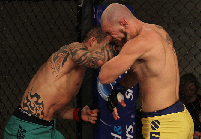SAO PAULO, BRAZIL - FEBRUARY 11: (L-R) Santiago Ponzinibbio punches Marcio "Pedra" Santos in their preliminary fight during filming of season two of The Ultimate Fighter Brazil on February 11, 2013 in Sao Paulo, Brazil. (Photo by Luiz Pires Dias/Zuffa LL