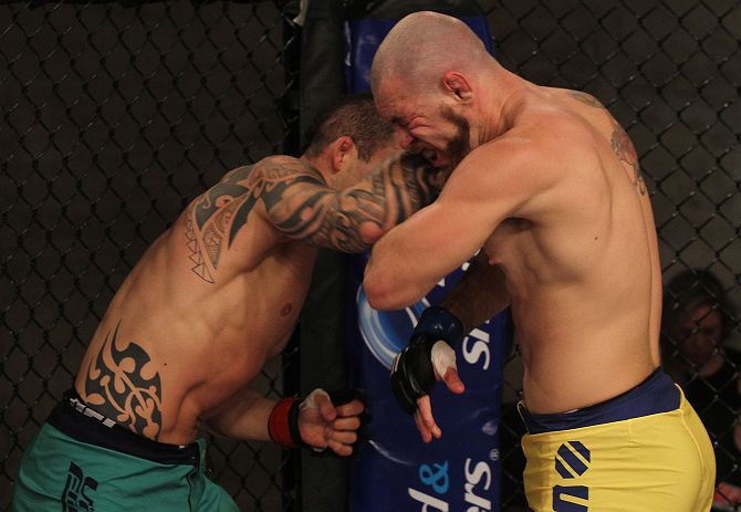 SAO PAULO, BRAZIL - FEBRUARY 11:  (L-R) Santiago Ponzinibbio punches Marcio "Pedra" Santos in their preliminary fight during filming of season two of The Ultimate Fighter Brazil on February 11, 2013 in Sao Paulo, Brazil. (Photo by Luiz Pires Dias/Zuffa LL