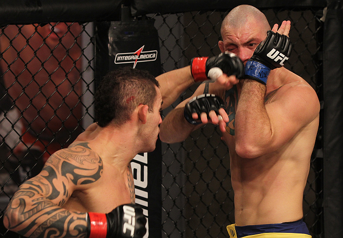 SAO PAULO, BRAZIL - FEBRUARY 11:  (L-R) Santiago Ponzinibbio punches Marcio "Pedra" Santos in their preliminary fight during filming of season two of The Ultimate Fighter Brazil on February 11, 2013 in Sao Paulo, Brazil. (Photo by Luiz Pires Dias/Zuffa LL