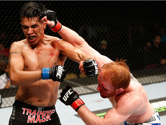 QUEBEC CITY, CANADA - APRIL 16:  (L-R) Mike de la Torre and Mark Bocek trade punches in their lightweight fight during the TUF Nations Finale at Colisee Pepsi on April 16, 2014 in Quebec City, Quebec, Canada. (Photo by Josh Hedges/Zuffa LLC/Zuffa LLC via 