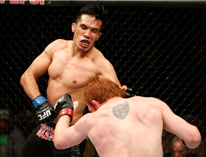 QUEBEC CITY, CANADA - APRIL 16:  (L-R) Mike de la Torre punches Mark Bocek in their lightweight fight during the TUF Nations Finale at Colisee Pepsi on April 16, 2014 in Quebec City, Quebec, Canada. (Photo by Josh Hedges/Zuffa LLC/Zuffa LLC via Getty Imag