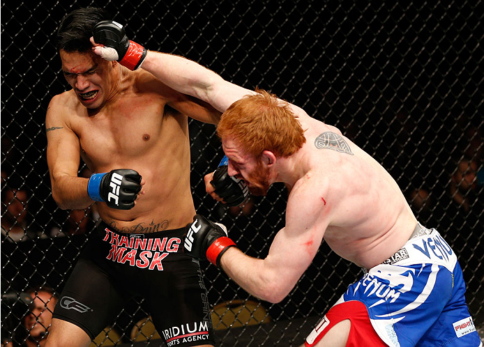 QUEBEC CITY, CANADA - APRIL 16:  (R-L) Mark Bocek punches Mike de la Torre in their lightweight fight during the TUF Nations Finale at Colisee Pepsi on April 16, 2014 in Quebec City, Quebec, Canada. (Photo by Josh Hedges/Zuffa LLC/Zuffa LLC via Getty Imag