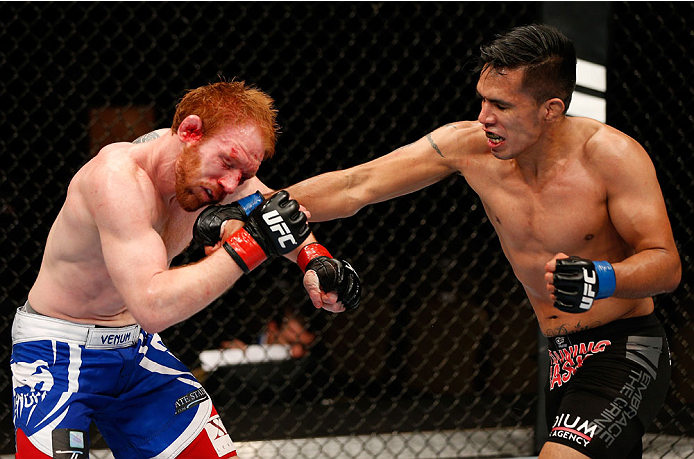 QUEBEC CITY, CANADA - APRIL 16:  (R-L) Mike de la Torre punches Mark Bocek in their lightweight fight during the TUF Nations Finale at Colisee Pepsi on April 16, 2014 in Quebec City, Quebec, Canada. (Photo by Josh Hedges/Zuffa LLC/Zuffa LLC via Getty Imag