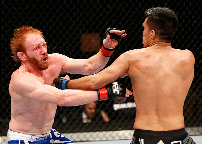 QUEBEC CITY, CANADA - APRIL 16:  (R-L) Mike de la Torre punches Mark Bocek in their lightweight fight during the TUF Nations Finale at Colisee Pepsi on April 16, 2014 in Quebec City, Quebec, Canada. (Photo by Josh Hedges/Zuffa LLC/Zuffa LLC via Getty Imag