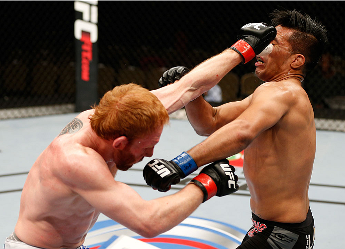 QUEBEC CITY, CANADA - APRIL 16:  (L-R) Mark Bocek punches Mike de la Torre in their lightweight fight during the TUF Nations Finale at Colisee Pepsi on April 16, 2014 in Quebec City, Quebec, Canada. (Photo by Josh Hedges/Zuffa LLC/Zuffa LLC via Getty Imag