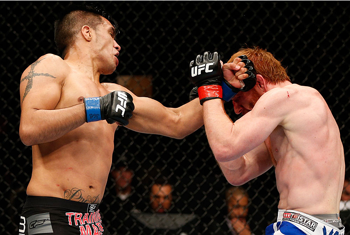 QUEBEC CITY, CANADA - APRIL 16:  (L-R) Mike de la Torre punches Mark Bocek in their lightweight fight during the TUF Nations Finale at Colisee Pepsi on April 16, 2014 in Quebec City, Quebec, Canada. (Photo by Josh Hedges/Zuffa LLC/Zuffa LLC via Getty Imag