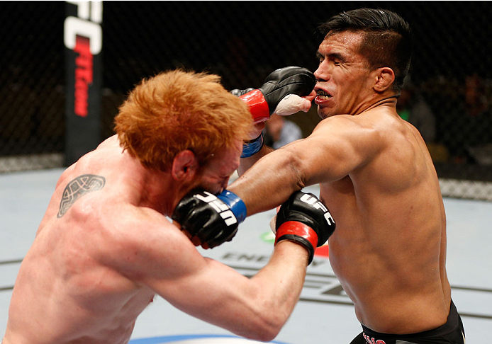 QUEBEC CITY, CANADA - APRIL 16:  (R-L) Mike de la Torre and Mark Bocek trade punches in their lightweight fight during the TUF Nations Finale at Colisee Pepsi on April 16, 2014 in Quebec City, Quebec, Canada. (Photo by Josh Hedges/Zuffa LLC/Zuffa LLC via 