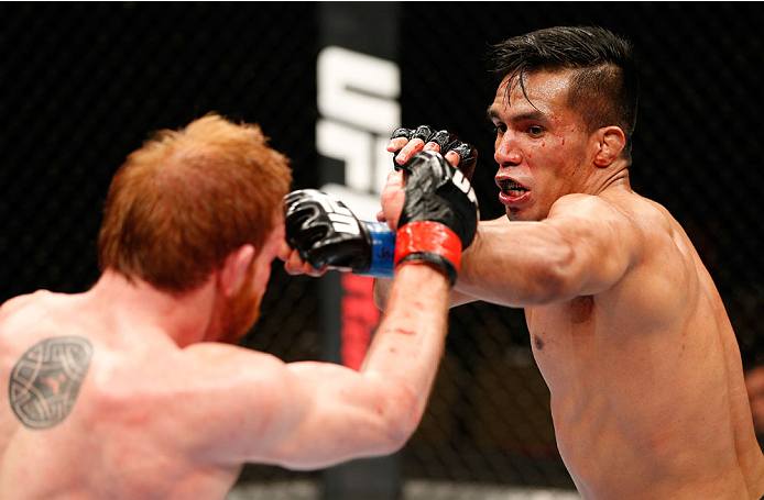 QUEBEC CITY, CANADA - APRIL 16:  (R-L) Mike de la Torre punches Mark Bocek in their lightweight fight during the TUF Nations Finale at Colisee Pepsi on April 16, 2014 in Quebec City, Quebec, Canada. (Photo by Josh Hedges/Zuffa LLC/Zuffa LLC via Getty Imag