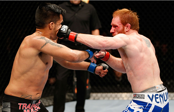 QUEBEC CITY, CANADA - APRIL 16: (R-L) Mark Bocek punches Mike de la Torre in their lightweight fight during the TUF Nations Finale at Colisee Pepsi on April 16, 2014 in Quebec City, Quebec, Canada. (Photo by Josh Hedges/Zuffa LLC/Zuffa LLC via Getty Imag