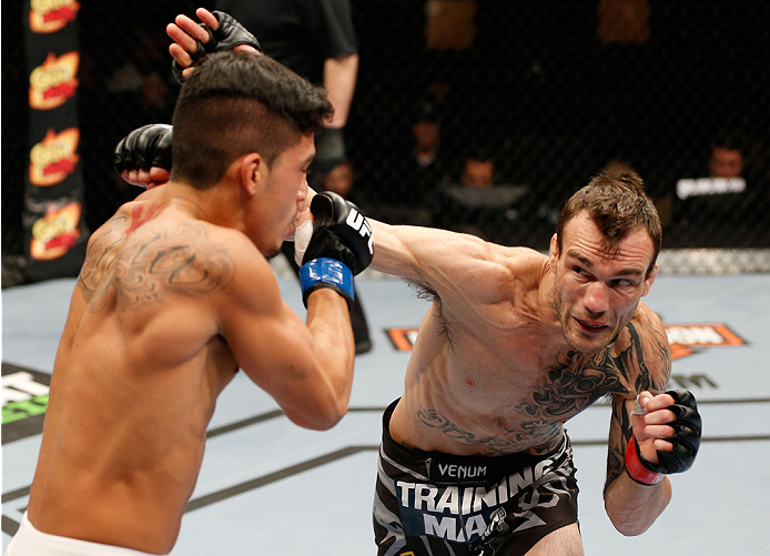 QUEBEC CITY, CANADA - APRIL 16:  (R-L) George Roop punches Dustin Kimura in their bantamweight fight during the TUF Nations Finale at Colisee Pepsi on April 16, 2014 in Quebec City, Quebec, Canada. (Photo by Josh Hedges/Zuffa LLC/Zuffa LLC via Getty Image