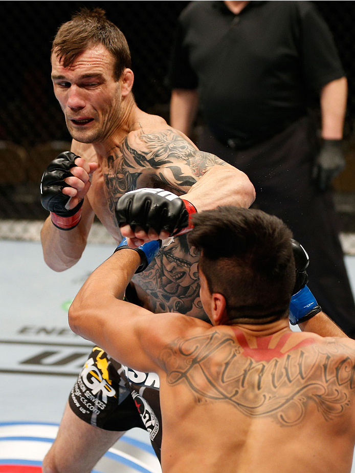 QUEBEC CITY, CANADA - APRIL 16:  (L-R) George Roop punches Dustin Kimura in their bantamweight fight during the TUF Nations Finale at Colisee Pepsi on April 16, 2014 in Quebec City, Quebec, Canada. (Photo by Josh Hedges/Zuffa LLC/Zuffa LLC via Getty Image