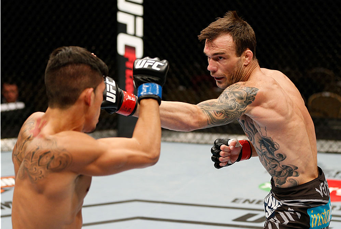 QUEBEC CITY, CANADA - APRIL 16:  (R-L) George Roop punches Dustin Kimura in their bantamweight fight during the TUF Nations Finale at Colisee Pepsi on April 16, 2014 in Quebec City, Quebec, Canada. (Photo by Josh Hedges/Zuffa LLC/Zuffa LLC via Getty Image