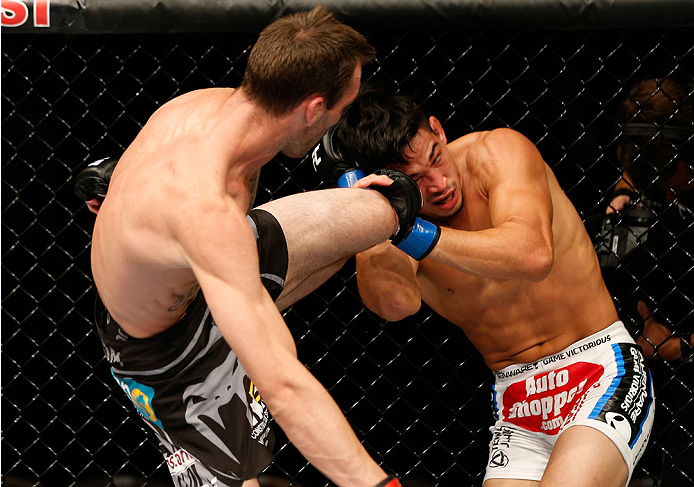 QUEBEC CITY, CANADA - APRIL 16:  (L-R) George Roop kicks Dustin Kimura in their bantamweight fight during the TUF Nations Finale at Colisee Pepsi on April 16, 2014 in Quebec City, Quebec, Canada. (Photo by Josh Hedges/Zuffa LLC/Zuffa LLC via Getty Images)