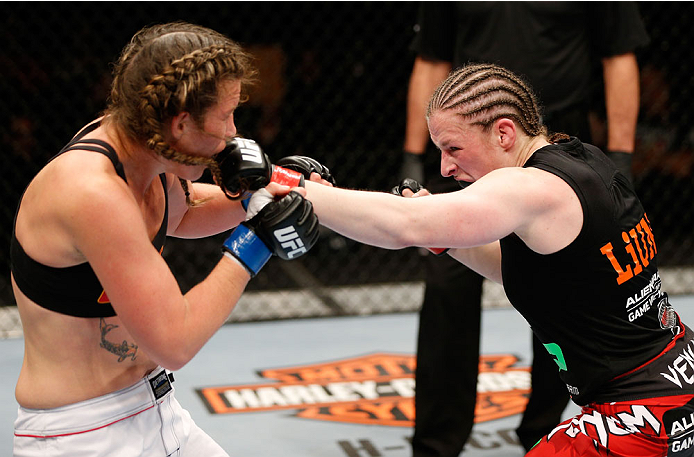 QUEBEC CITY, CANADA - APRIL 16:  (R-L) Sarah Kaufman punches Leslie Smith in their women's bantamweight fight during the TUF Nations Finale at Colisee Pepsi on April 16, 2014 in Quebec City, Quebec, Canada. (Photo by Josh Hedges/Zuffa LLC/Zuffa LLC via Ge