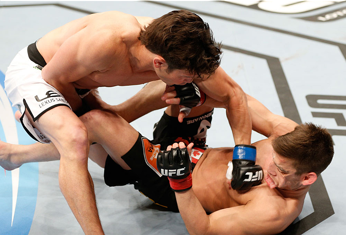 QUEBEC CITY, CANADA - APRIL 16:  (L-R) KJ Noons knocks out Sam Stout with a series of punches in their welterweight fight during the TUF Nations Finale at Colisee Pepsi on April 16, 2014 in Quebec City, Quebec, Canada. (Photo by Josh Hedges/Zuffa LLC/Zuff