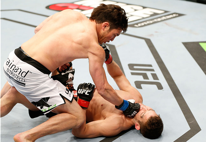 QUEBEC CITY, CANADA - APRIL 16:  (L-R) KJ Noons knocks out Sam Stout with a series of punches in their welterweight fight during the TUF Nations Finale at Colisee Pepsi on April 16, 2014 in Quebec City, Quebec, Canada. (Photo by Josh Hedges/Zuffa LLC/Zuff