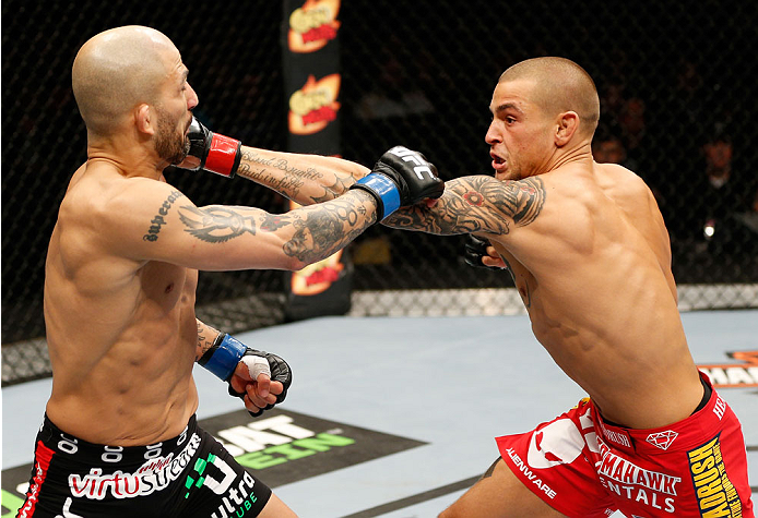 QUEBEC CITY, CANADA - APRIL 16:  (R-L) Dustin Poirier punches Akira Corassani in their featherweight fight during the TUF Nations Finale at Colisee Pepsi on April 16, 2014 in Quebec City, Quebec, Canada. (Photo by Josh Hedges/Zuffa LLC/Zuffa LLC via Getty