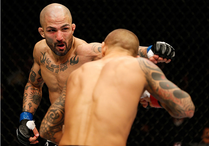 QUEBEC CITY, CANADA - APRIL 16:  (L-R) Akira Corassani punches Dustin Poirier in their featherweight fight during the TUF Nations Finale at Colisee Pepsi on April 16, 2014 in Quebec City, Quebec, Canada. (Photo by Josh Hedges/Zuffa LLC/Zuffa LLC via Getty