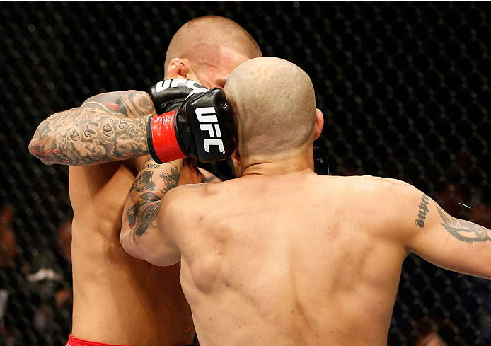 QUEBEC CITY, CANADA - APRIL 16:  (L-R) Dustin Poirier punches Akira Corassani in their featherweight fight during the TUF Nations Finale at Colisee Pepsi on April 16, 2014 in Quebec City, Quebec, Canada. (Photo by Josh Hedges/Zuffa LLC/Zuffa LLC via Getty