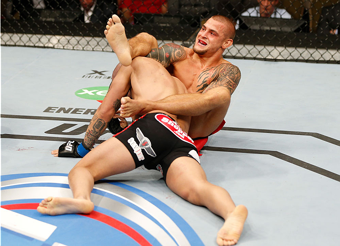 QUEBEC CITY, CANADA - APRIL 16:  (R-L) Dustin Poirier attempts to secure a choke submission against Akira Corassani in their featherweight fight during the TUF Nations Finale at Colisee Pepsi on April 16, 2014 in Quebec City, Quebec, Canada. (Photo by Jos