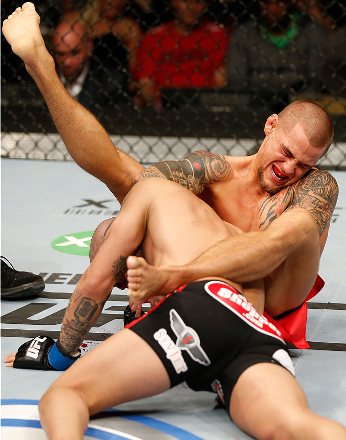 QUEBEC CITY, CANADA - APRIL 16:  (R-L) Dustin Poirier attempts to secure a choke submission against Akira Corassani in their featherweight fight during the TUF Nations Finale at Colisee Pepsi on April 16, 2014 in Quebec City, Quebec, Canada. (Photo by Jos