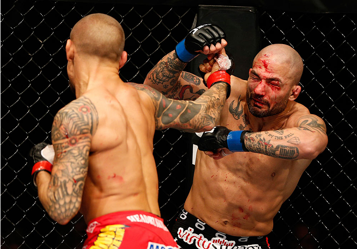 QUEBEC CITY, CANADA - APRIL 16:  (L-R) Dustin Poirier punches Akira Corassani in their featherweight fight during the TUF Nations Finale at Colisee Pepsi on April 16, 2014 in Quebec City, Quebec, Canada. (Photo by Josh Hedges/Zuffa LLC/Zuffa LLC via Getty