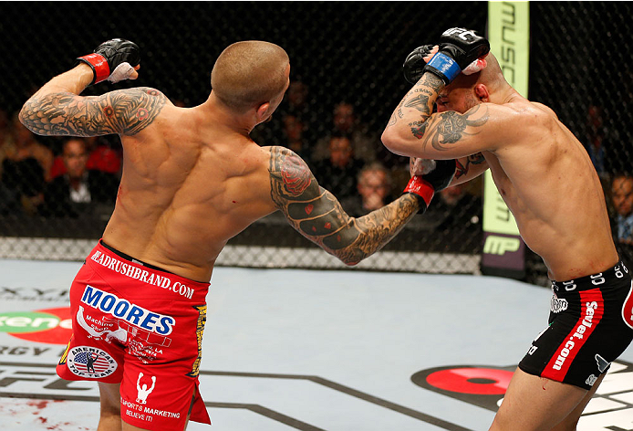 QUEBEC CITY, CANADA - APRIL 16:  (L-R) Dustin Poirier punches Akira Corassani in their featherweight fight during the TUF Nations Finale at Colisee Pepsi on April 16, 2014 in Quebec City, Quebec, Canada. (Photo by Josh Hedges/Zuffa LLC/Zuffa LLC via Getty