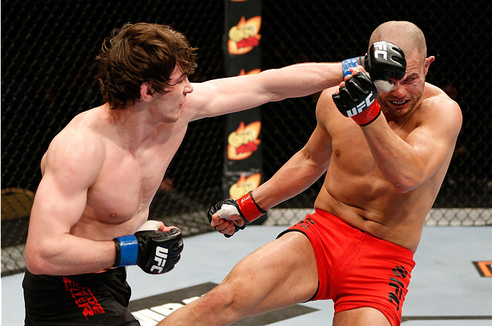 QUEBEC CITY, CANADA - APRIL 16:  (L-R) Olivier Aubin-Mercier punches Chad Laprise in their welterweight fight during the TUF Nations Finale at Colisee Pepsi on April 16, 2014 in Quebec City, Quebec, Canada. (Photo by Josh Hedges/Zuffa LLC/Zuffa LLC via Ge