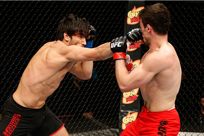 QUEBEC CITY, CANADA - APRIL 16:  (L-R) Elias Theodorou punches Sheldon Wescott in their middleweight fight during the TUF Nations Finale at Colisee Pepsi on April 16, 2014 in Quebec City, Quebec, Canada. (Photo by Josh Hedges/Zuffa LLC/Zuffa LLC via Getty