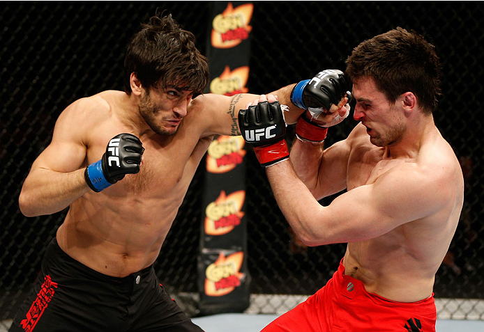 QUEBEC CITY, CANADA - APRIL 16:  (L-R) Elias Theodorou punches Sheldon Wescott in their middleweight fight during the TUF Nations Finale at Colisee Pepsi on April 16, 2014 in Quebec City, Quebec, Canada. (Photo by Josh Hedges/Zuffa LLC/Zuffa LLC via Getty