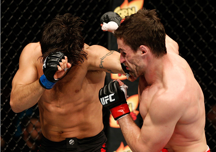 QUEBEC CITY, CANADA - APRIL 16:  (L-R) Elias Theodorou punches Sheldon Wescott in their middleweight fight during the TUF Nations Finale at Colisee Pepsi on April 16, 2014 in Quebec City, Quebec, Canada. (Photo by Josh Hedges/Zuffa LLC/Zuffa LLC via Getty