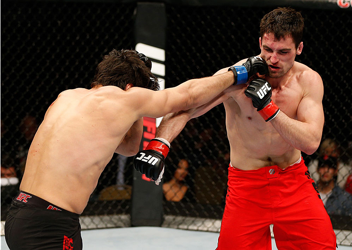 QUEBEC CITY, CANADA - APRIL 16:  (L-R) Elias Theodorou punches Sheldon Wescott in their middleweight fight during the TUF Nations Finale at Colisee Pepsi on April 16, 2014 in Quebec City, Quebec, Canada. (Photo by Josh Hedges/Zuffa LLC/Zuffa LLC via Getty