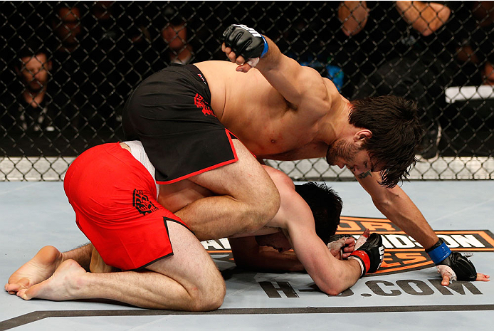 QUEBEC CITY, CANADA - APRIL 16:  (L-R) Elias Theodorou punches Sheldon Wescott in their middleweight fight during the TUF Nations Finale at Colisee Pepsi on April 16, 2014 in Quebec City, Quebec, Canada. (Photo by Josh Hedges/Zuffa LLC/Zuffa LLC via Getty