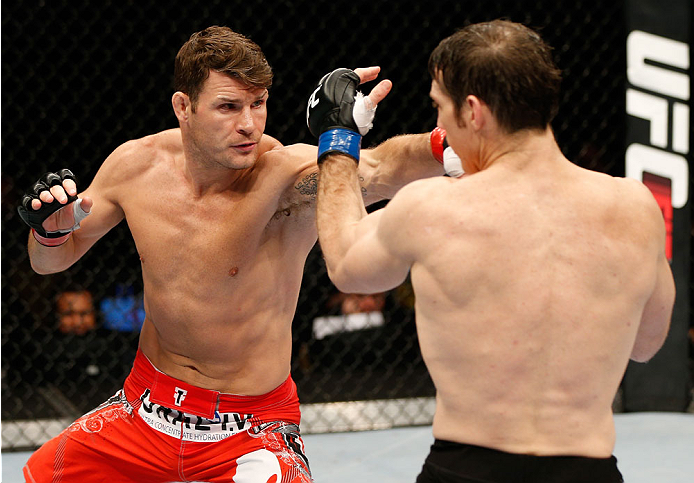 QUEBEC CITY, CANADA - APRIL 16:  (L-R) Michael Bisping punches Tim Kennedy in their middleweight fight during the TUF Nations Finale at Colisee Pepsi on April 16, 2014 in Quebec City, Quebec, Canada. (Photo by Josh Hedges/Zuffa LLC/Zuffa LLC via Getty Ima