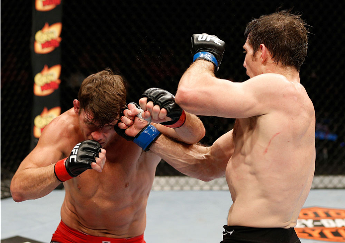 QUEBEC CITY, CANADA - APRIL 16:  (R-L) Tim Kennedy punches Michael Bisping in their middleweight fight during the TUF Nations Finale at Colisee Pepsi on April 16, 2014 in Quebec City, Quebec, Canada. (Photo by Josh Hedges/Zuffa LLC/Zuffa LLC via Getty Ima