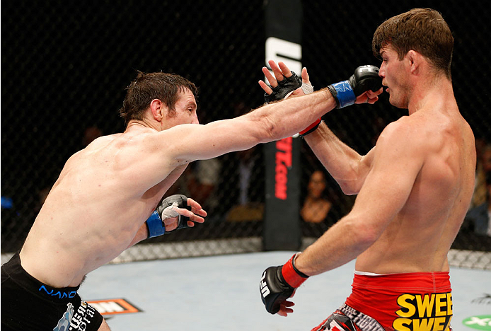 QUEBEC CITY, CANADA - APRIL 16:  (L-R) Tim Kennedy punches Michael Bisping in their middleweight fight during the TUF Nations Finale at Colisee Pepsi on April 16, 2014 in Quebec City, Quebec, Canada. (Photo by Josh Hedges/Zuffa LLC/Zuffa LLC via Getty Ima