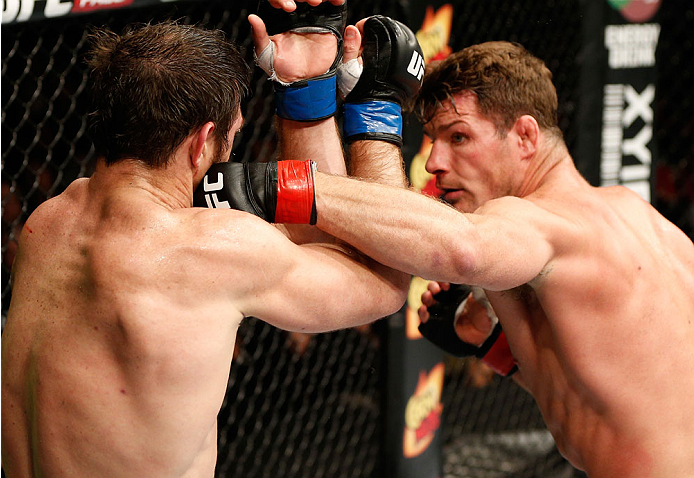 QUEBEC CITY, CANADA - APRIL 16:  (R-L) Michael Bisping punches Tim Kennedy in their middleweight fight during the TUF Nations Finale at Colisee Pepsi on April 16, 2014 in Quebec City, Quebec, Canada. (Photo by Josh Hedges/Zuffa LLC/Zuffa LLC via Getty Ima