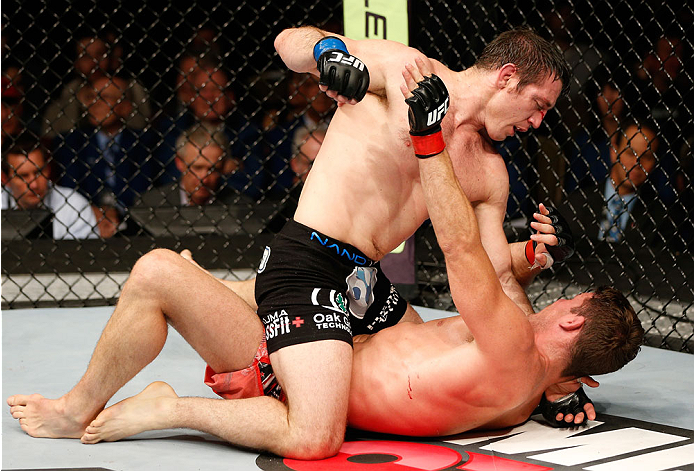 QUEBEC CITY, CANADA - APRIL 16:  (L-R) Tim Kennedy punches Michael Bisping in their middleweight fight during the TUF Nations Finale at Colisee Pepsi on April 16, 2014 in Quebec City, Quebec, Canada. (Photo by Josh Hedges/Zuffa LLC/Zuffa LLC via Getty Ima