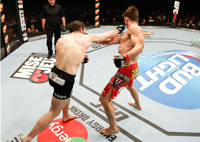 QUEBEC CITY, CANADA - APRIL 16:  (L-R) Tim Kennedy punches Michael Bisping in their middleweight fight during the TUF Nations Finale at Colisee Pepsi on April 16, 2014 in Quebec City, Quebec, Canada. (Photo by Josh Hedges/Zuffa LLC/Zuffa LLC via Getty Ima