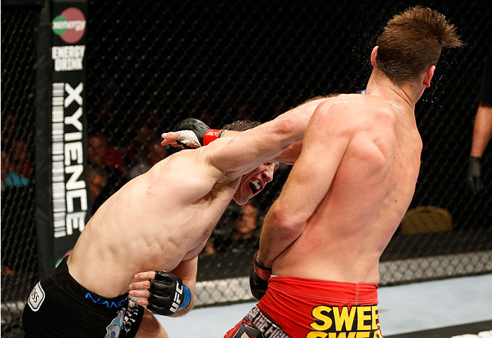 QUEBEC CITY, CANADA - APRIL 16:  (L-R) Tim Kennedy punches Michael Bisping in their middleweight fight during the TUF Nations Finale at Colisee Pepsi on April 16, 2014 in Quebec City, Quebec, Canada. (Photo by Josh Hedges/Zuffa LLC/Zuffa LLC via Getty Ima